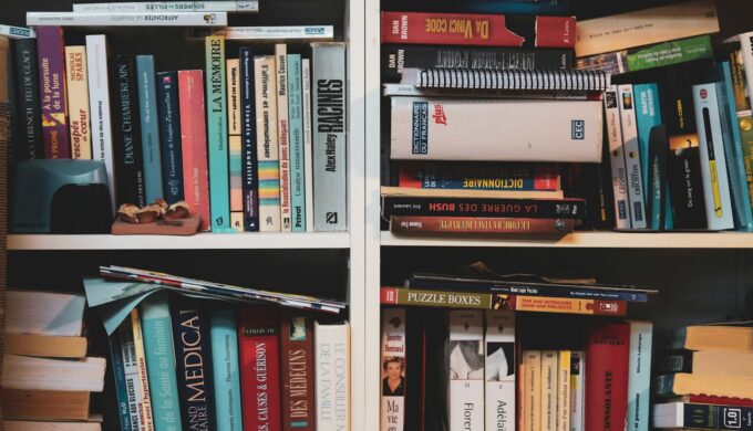 books on white wooden shelf